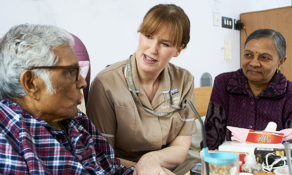 nursing associate talks to patient and relative