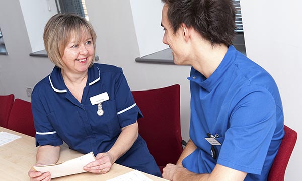 Two nurses talking. Photo: Science Photo Library