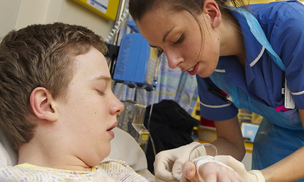 nurse tends to boy's bandage