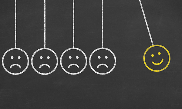 executive balls with happy face and frowning faces