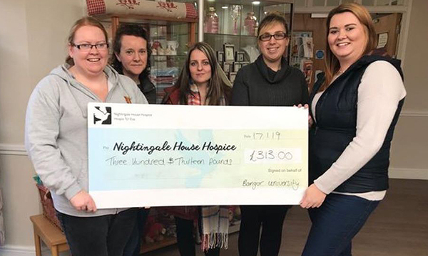 Bangor University nursing society representatives presenting a donation cheque to a local hospice
