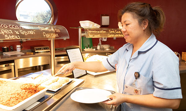 Picture shows a staff member at the canteen of a hospice in London. Lack of breaks and junk food from vending machines are said to contribute to nurses being overweight or obese, and protected mealtimes are being advocated to help tackle the issue.