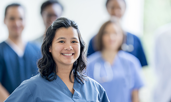 Picture shows a group of overseas nurses, with a young woman smiling in the foreground. The article says the international recruitment solution cannot be ignored.