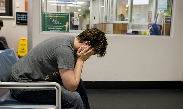 A patient with their head in their hands
