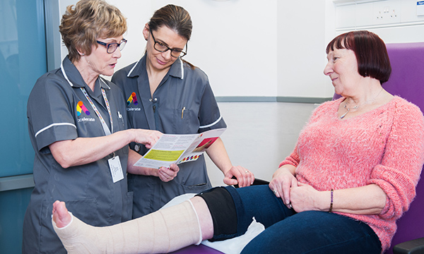 Accelerate director of education Karen Staines and wound care specialist Gabriela Kom, with a patient