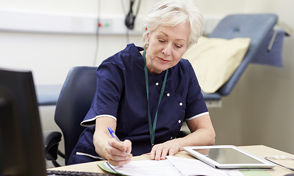 Picture shows a female medic sitting at a desk and writing. The health secretary’s humorous defence of his pledge on nurse numbers takes the focus off the real point, says James Buchan.