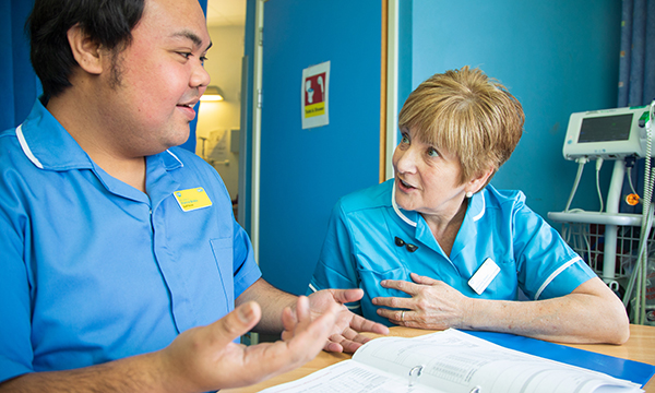Older nurse mentoring a young nurse