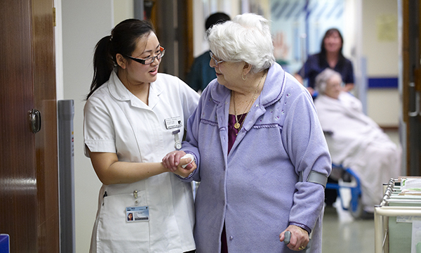 Picture of a nursing student caring for an older patient