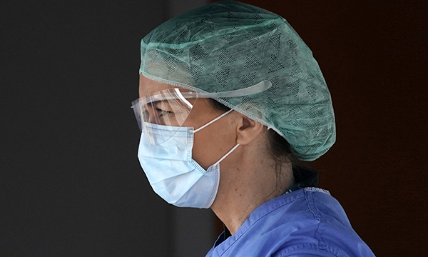 Picture shows a medic in protective gear. Advice to reuse gowns or use alternatives has raises concerns over safety of staff.