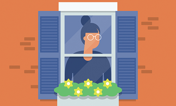 Image of a young woman looking out of the window while in isolation