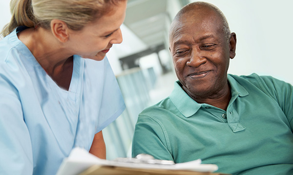 Nurse talking to a patient and taking notes