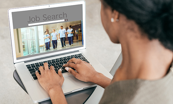 woman does an online search for a job as prime minister says he wants more nurses recruited to NHS in England