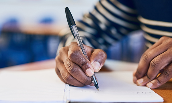 Image of someone writing in a journal, which can help ease distress and anxiety