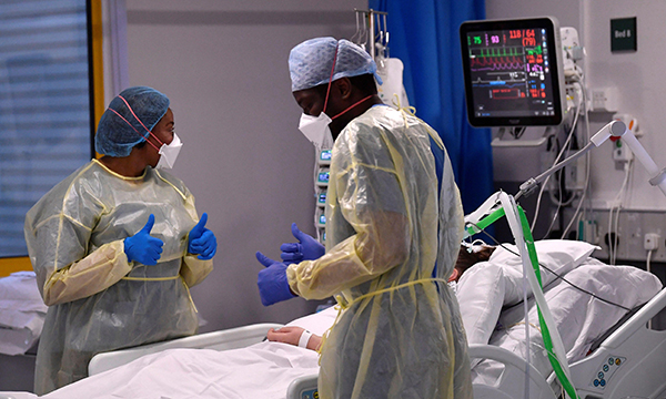 Nurses react as they treat a COVID-19 patient in the intensive care unit at Milton Keynes University Hospital