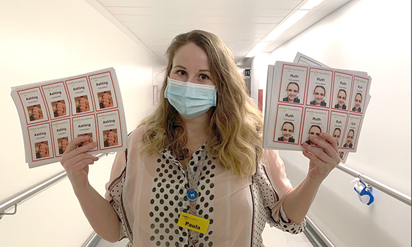 Paula Ryeland of Whittington Health in London shows the badges staff have been given to put patients at ease during coronavirus padnemic