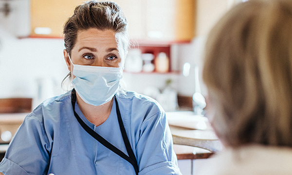 Picture shows a community nurse wearing a mask