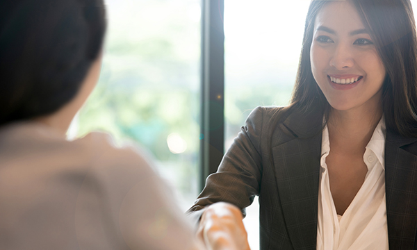 woman in a formal meeting shakes hands 