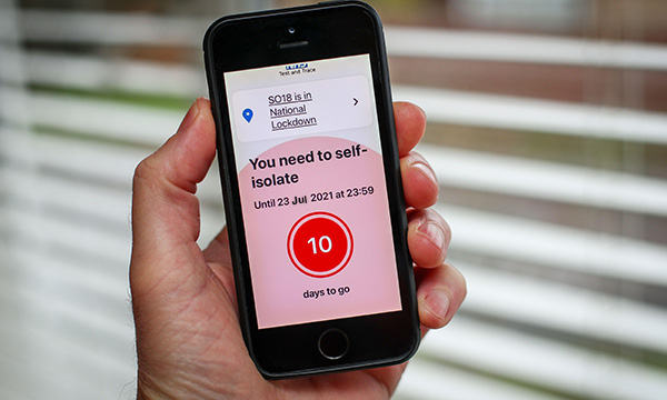 Picture of a smart phone screen showing a message to self-isolate