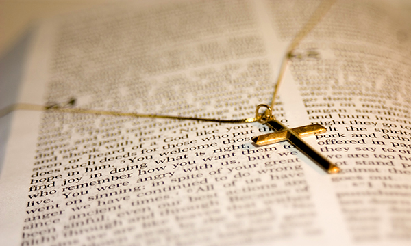 Cross necklace rests on a Bible – nurse takes ex-employer to tribunal, claiming it did not allow her to show this Christian symbol