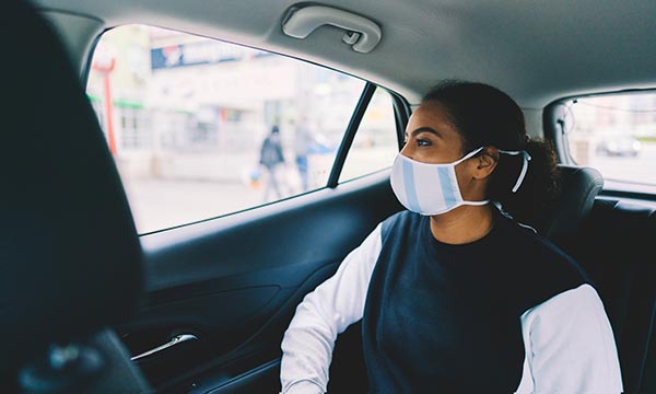 Woman in the back of a taxi looking out the window