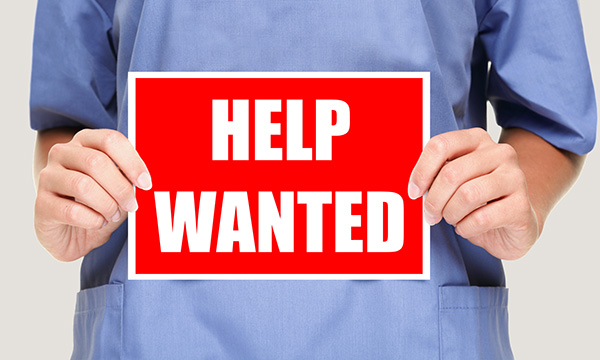 Nurses holds sign saying 'help wanted' as NHS leaders reveal staffing worries