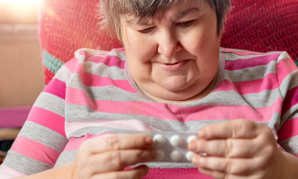 Woman holds drugs blister pack