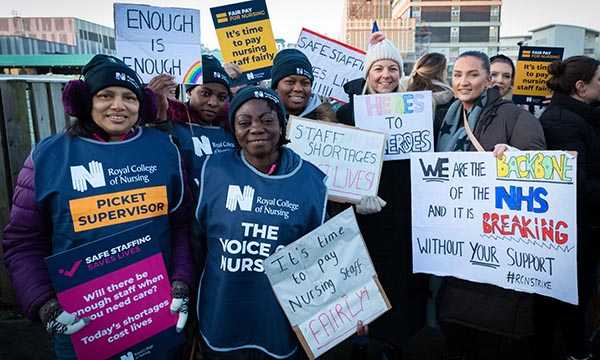 Nurses holding placards on a picket line outside Aintree University Hospital in Liverpool