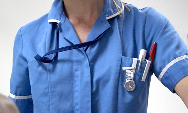 Partial picture of someone dressed in nursing uniform