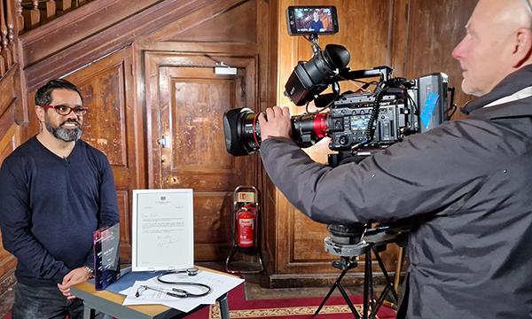 Nurse Rohit Sagoo smiles at the TV camera during filming of special nursing edition of Antiques Roadshow