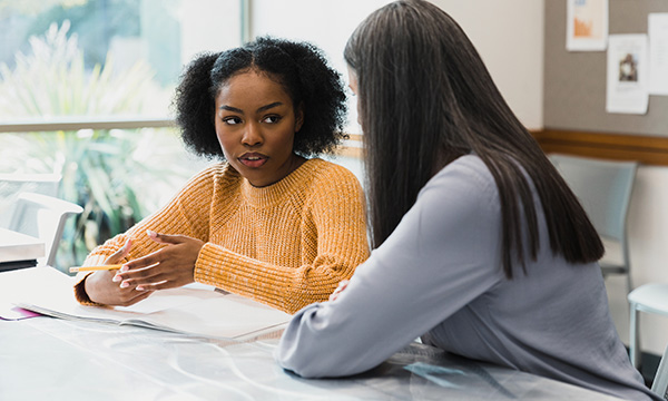 Two female nursing students chatting about their course work: it is coming up to five years since the Nursing and Midwifery Council overhauled its proficiency standards, which provide the basis for nurse education