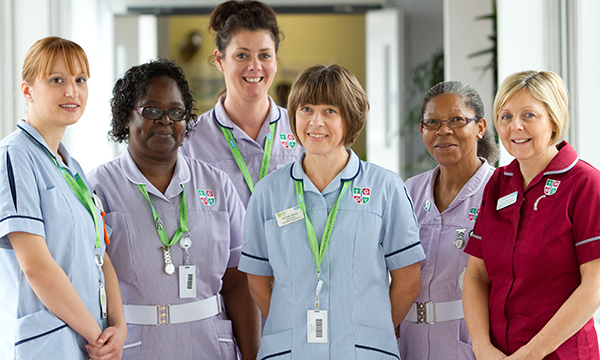 A group of nurses dressed in various uniforms