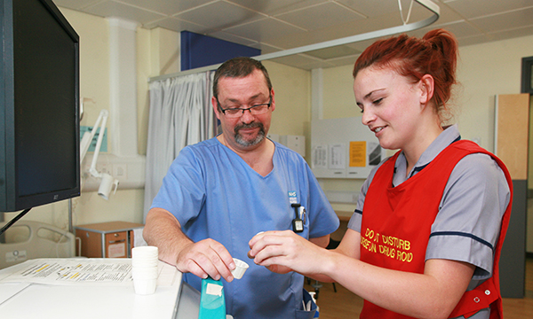 Photo of nursing student on a placement - views are divided on whether the number of placement hours should be cut