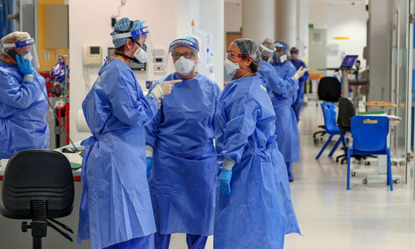 Nurses on a ward wearing full personal protective equipment during the COVID-19 pandemic
