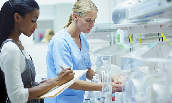 A nurse being observed and marked while doing a clinical task 