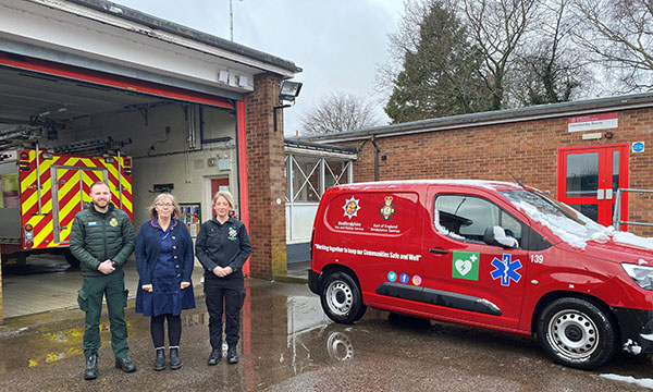 A picture of the Bedfordshire falls service team, including a nurse, in front of a fire engine
