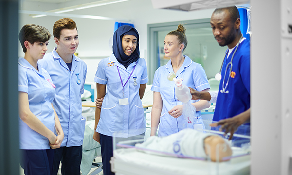 Children and young people nursing students learn and ask questions about baby incubation in a simulated exercise