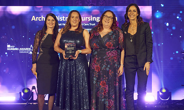Arches district nursing team members Orla Glennon and Martina McCarney (centre, left and right) receive the Patient’s Choice award on behalf of the team at the RCN Nursing Awards 2023. They are pictured with award presenter Emma Moore (left) and awards host Julia Bradbury