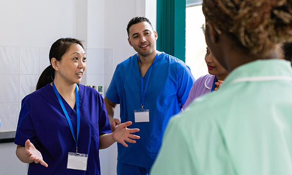 Photo of nurse leader talking to team, illustrating a story about a campaign that explores leadership