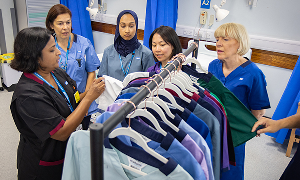 National uniforms: staff at Northwick Park Hospital inspect the range of new uniforms for healthcare staff across NHS England, which are hanging on a clothes rail