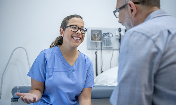 New survey reveals that 80% of urgent treatment centre patients felt staff definitely listened to them: emergency nurse discusses condition and treatment with a patient