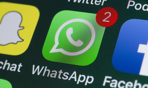 WhatsApp use by nursing students: close-up of the WhatsApp icon on a smartphone screen, alongside other social media icons