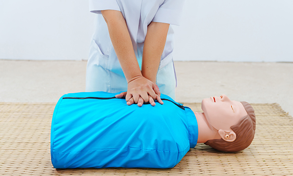 CPR nurse training: a nurse using a manikin in a cardiopulmonary resuscitation training session