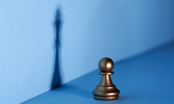 Learning leadership as a nursing student: chess pawn signifying a student casts shadow that is a more powerful piece, showing students can start being leaders
