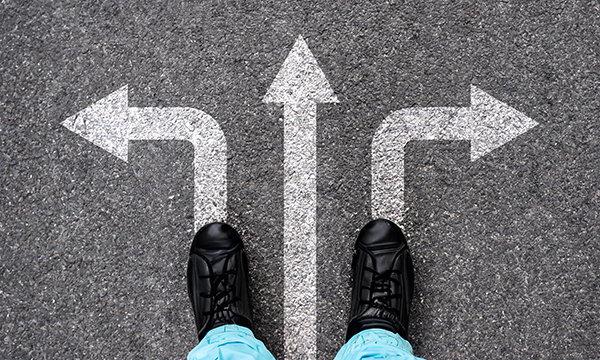 Moving sideways in nursing: nurse stands at junction of three arrows pointing in different directions