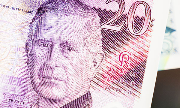 Nursing staff in England’s NHS are still waiting for news of an already-delayed 2025-26 pay offer: close-up shot of a £20 note