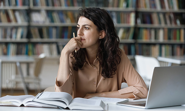 Practising reflection: a nursing student sits at a desk in a library
