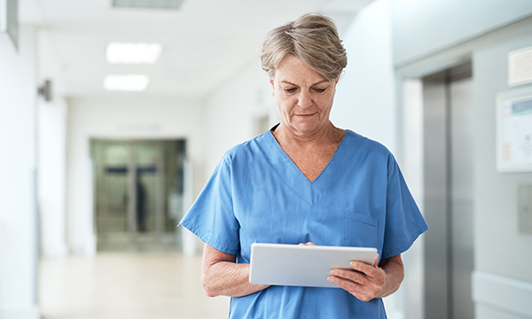 Back to the Floor: a senior nurse involved in direct patient care using an e-pad on the ward