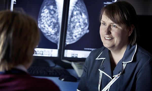 Advanced practice: a nursing practitioner discusses a mammogram with a patient