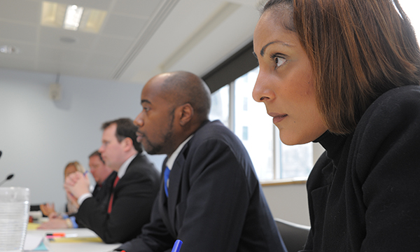 NMC fitness to practise process: panel of men and women in business suits sit in a row looking grave as they face unseen person