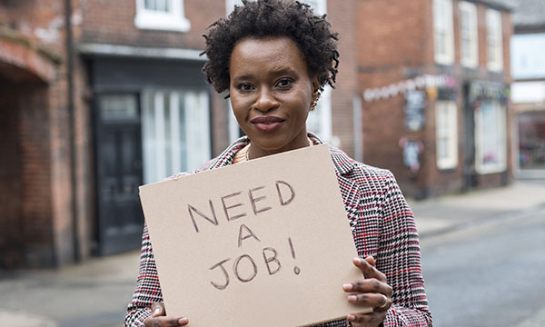 Newly registered nurses are unemployed and demoralised: young woman holds up a sign reading ‘need a job’